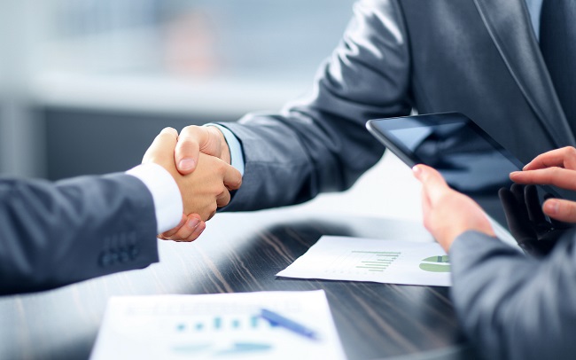 shaking hands in a business environment